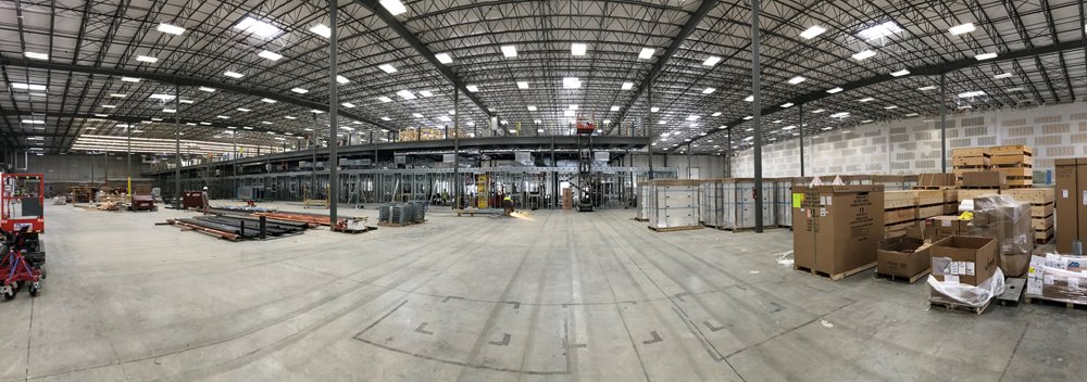 Completed installation of cleanroom manufacturing space, with adjacent storage, and mechanical mezzanine above. 